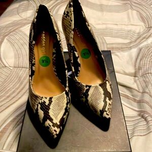 Brown and white snake print shoes. Heels are 4 inches. Never been worn
